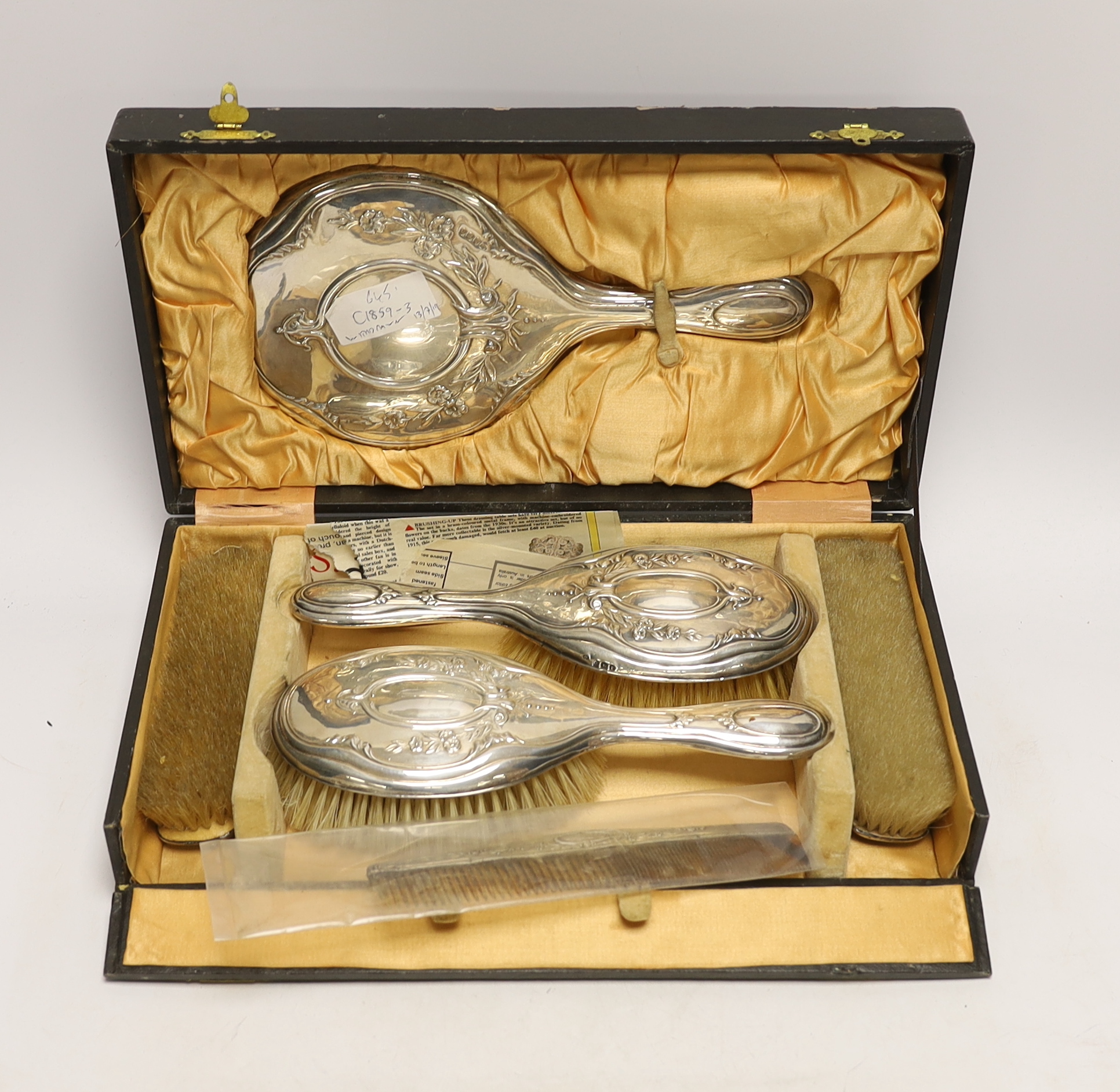 A cased silver four piece dressing table set.